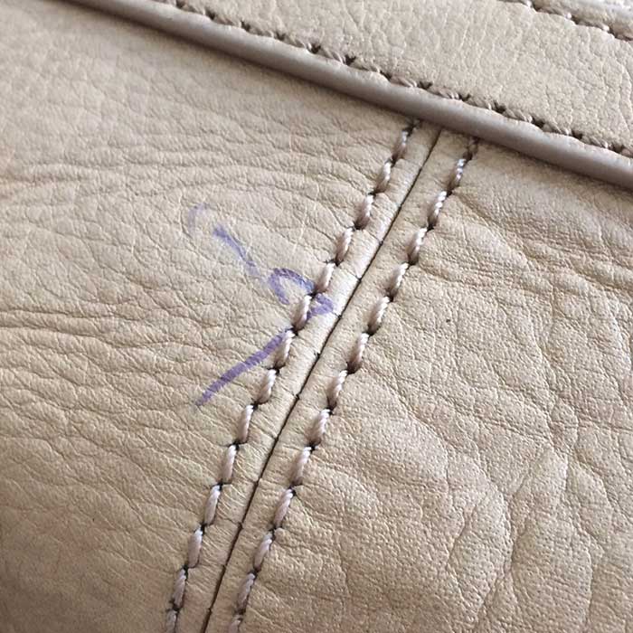 How to remove stain from leather purse? It was in my closest for a month  unused, and while using it last time I didn't spill anything on it to cause  the stain :