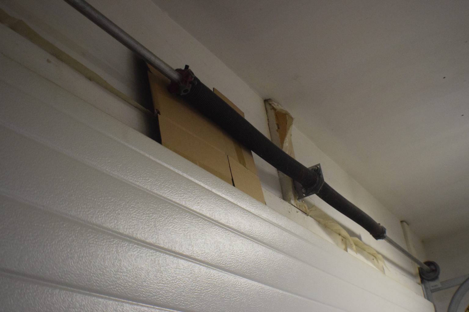 How to Fix a Squeaky Garage Door - CarDboarD UnDer Torsion Spring.jpg 66286 1536x1024