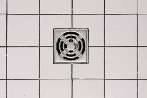 shower drain on white tile floor