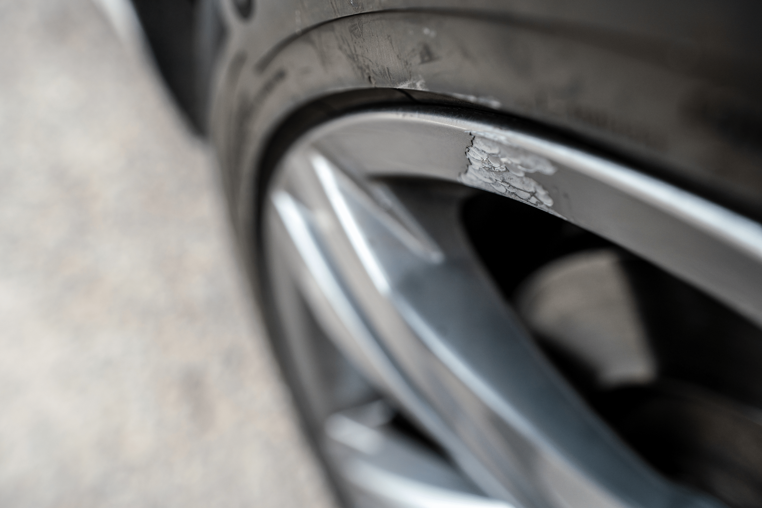 Aluminum car wheel with damage.