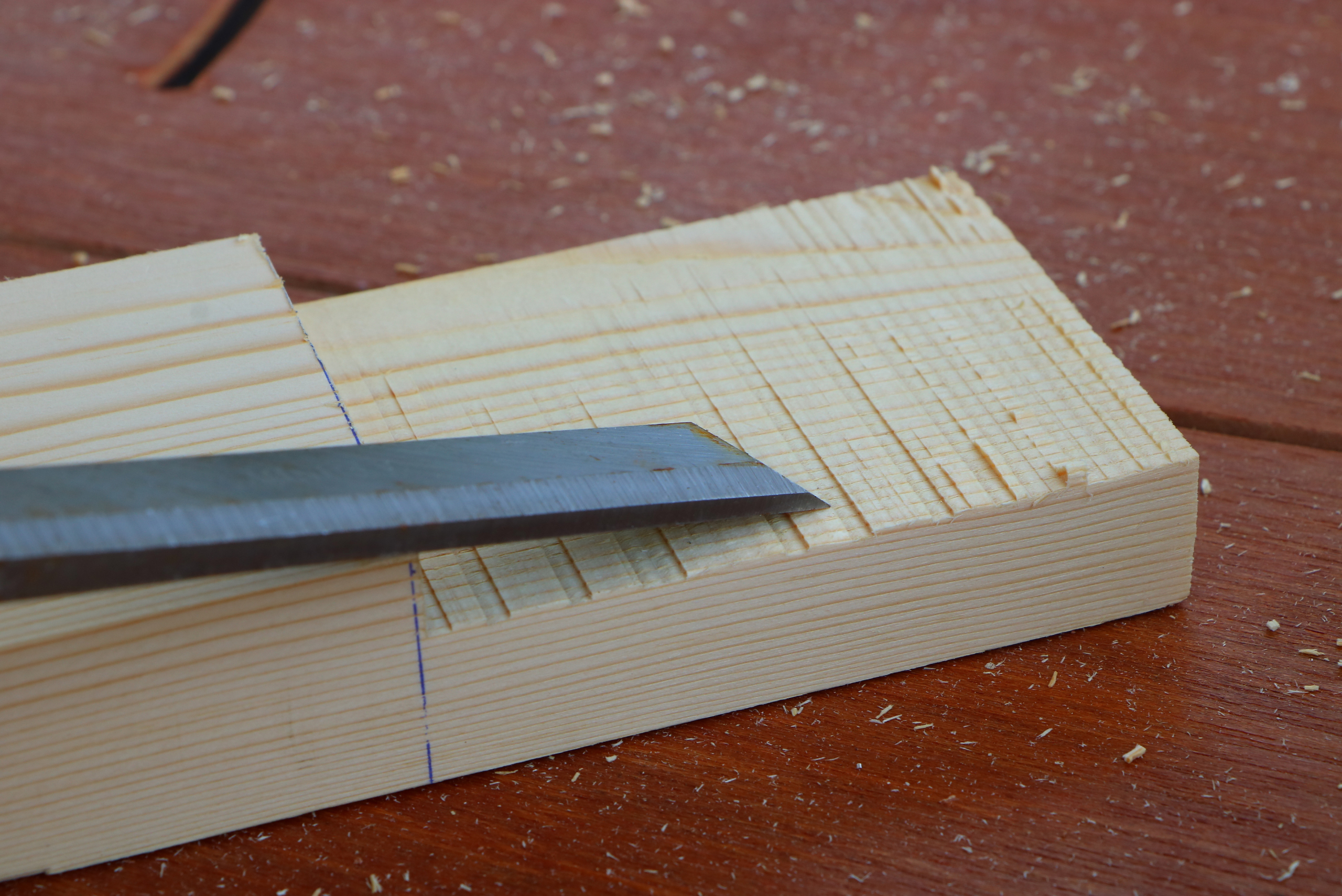 Using a chisel to clean up a rabbit router cut.