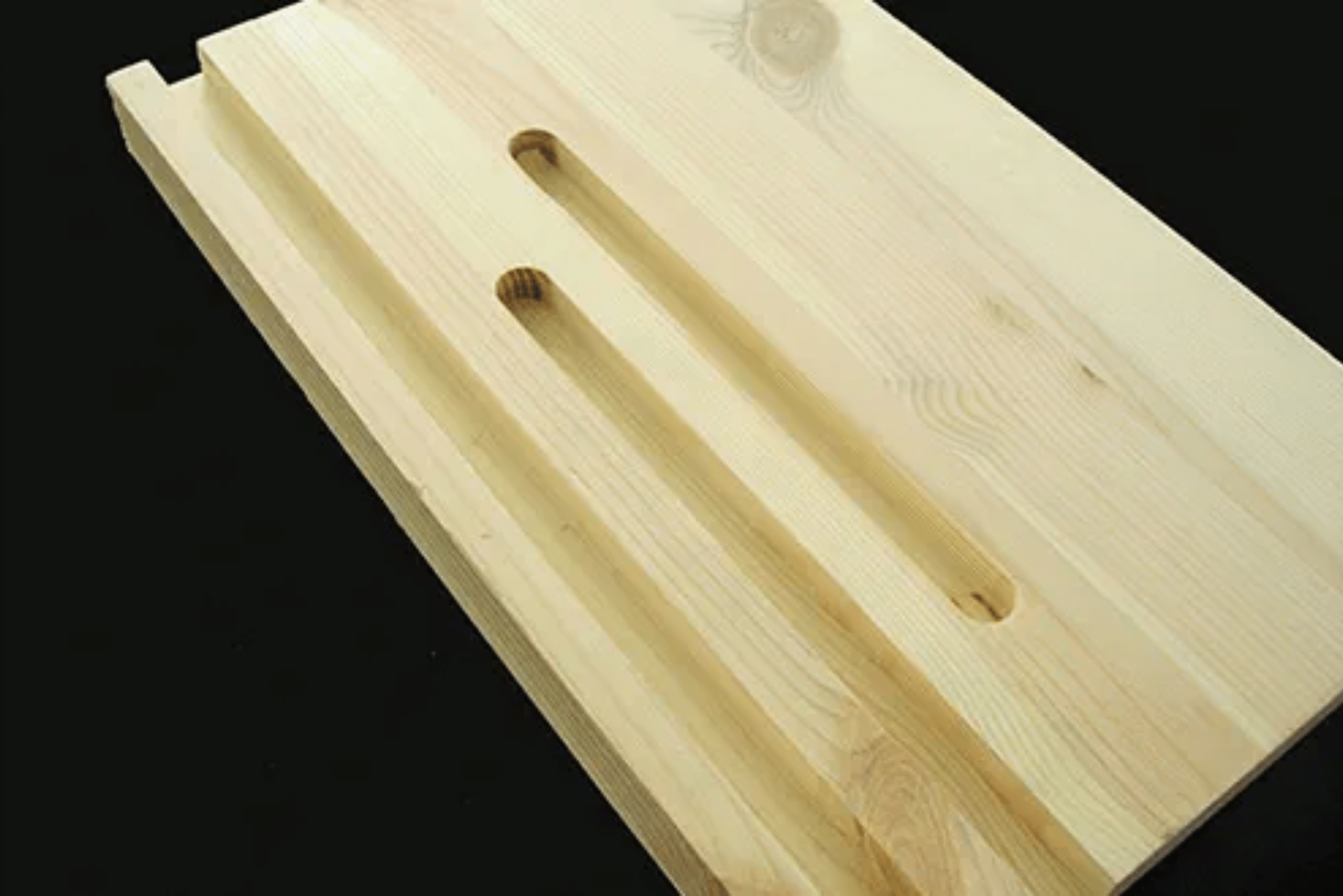 A wooden board with grooves router cuts.