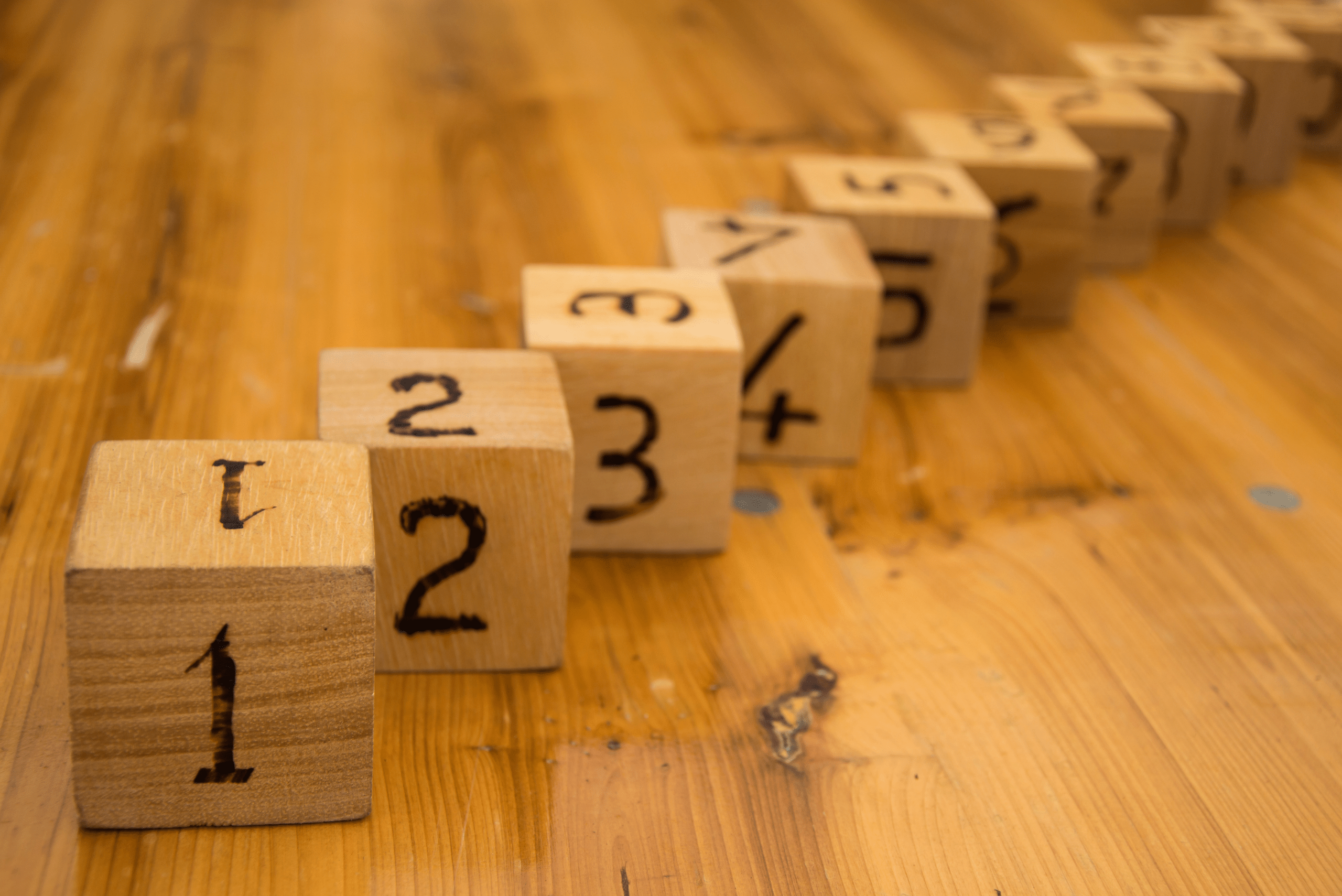 A bunch of wooden dice with numbers on them.