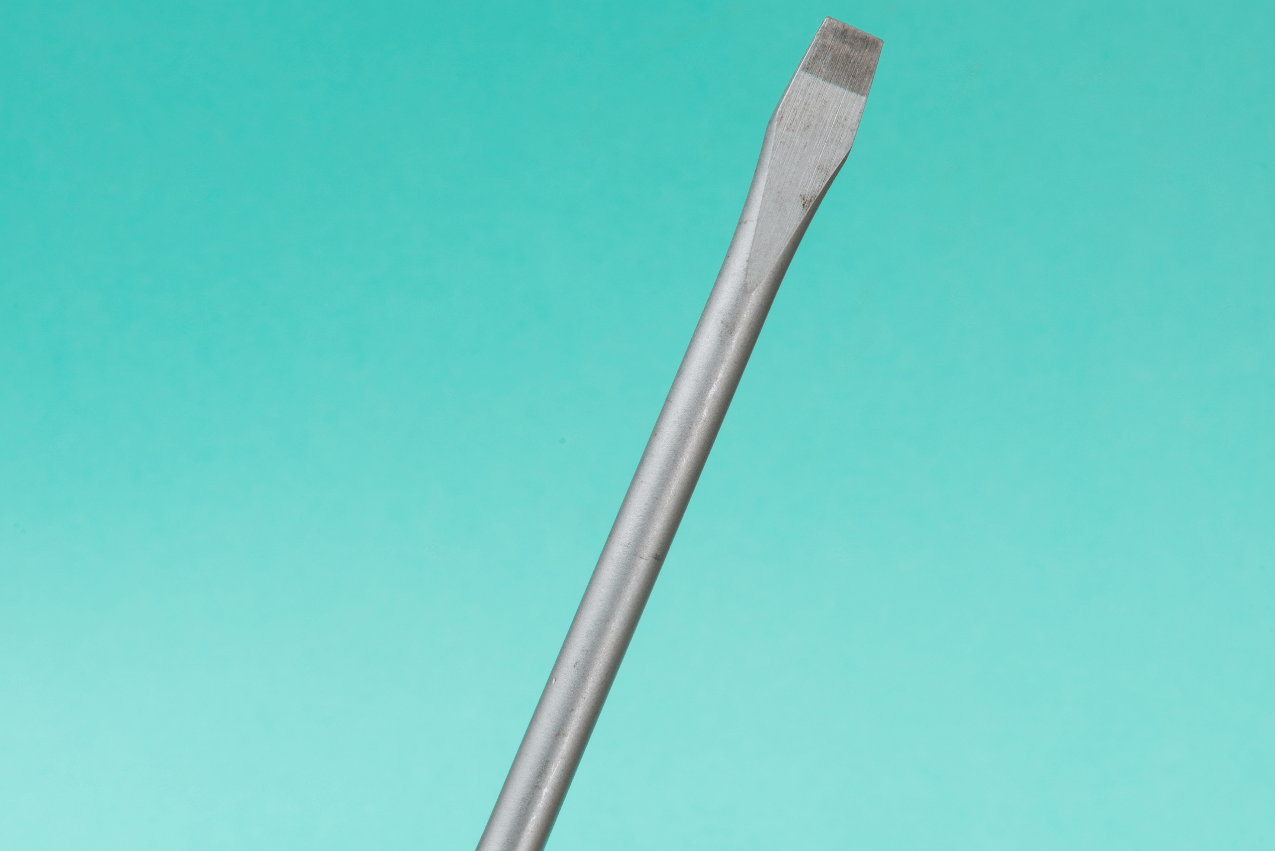 Closeup of the tip of a flathead screwdriver.