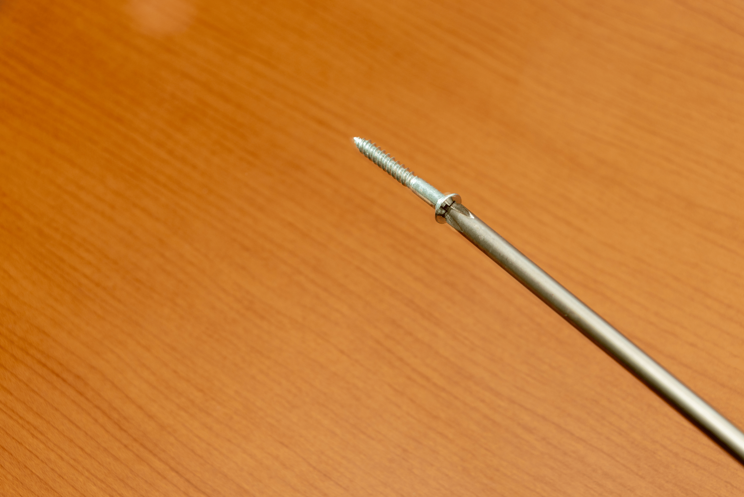 a magnetic screwdriver holding up a screw.