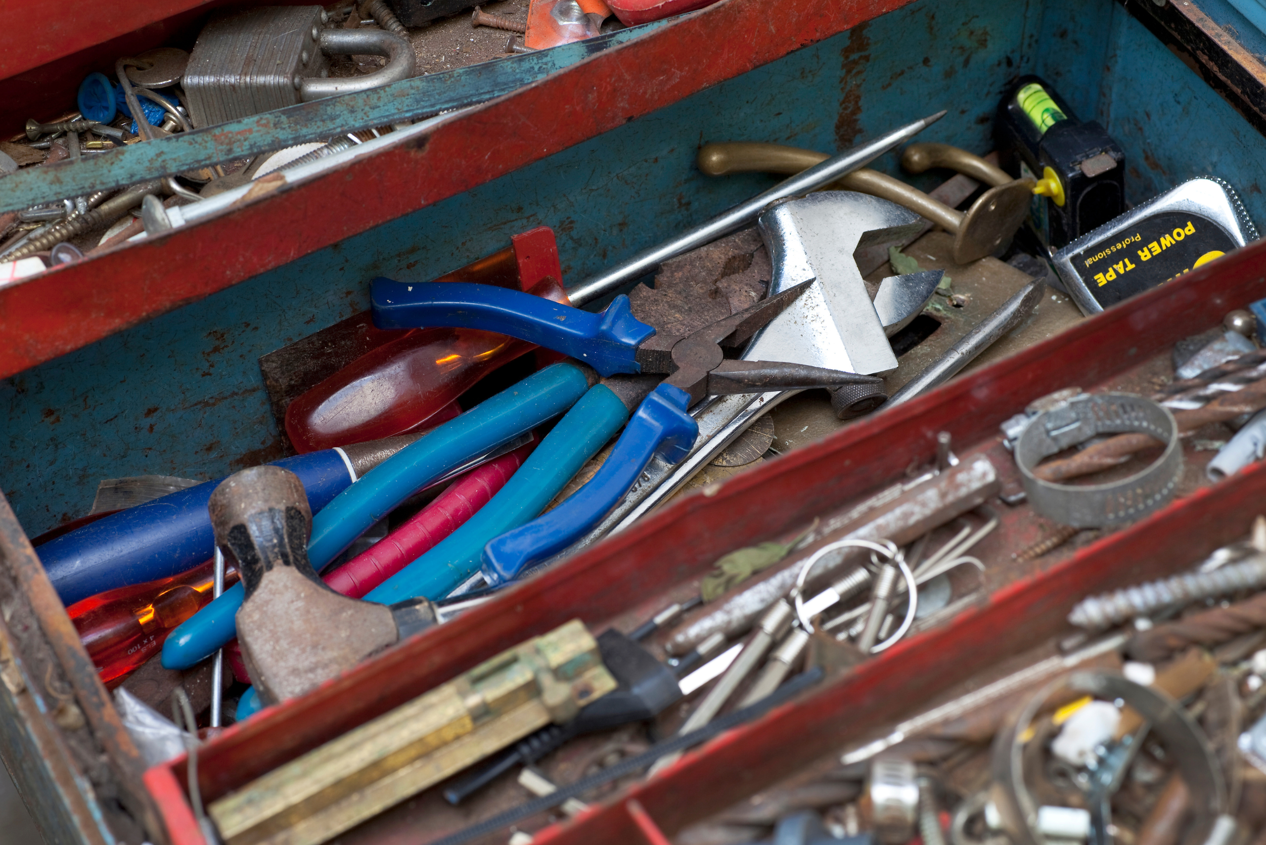 An assortment of tools and materials in toolbox.