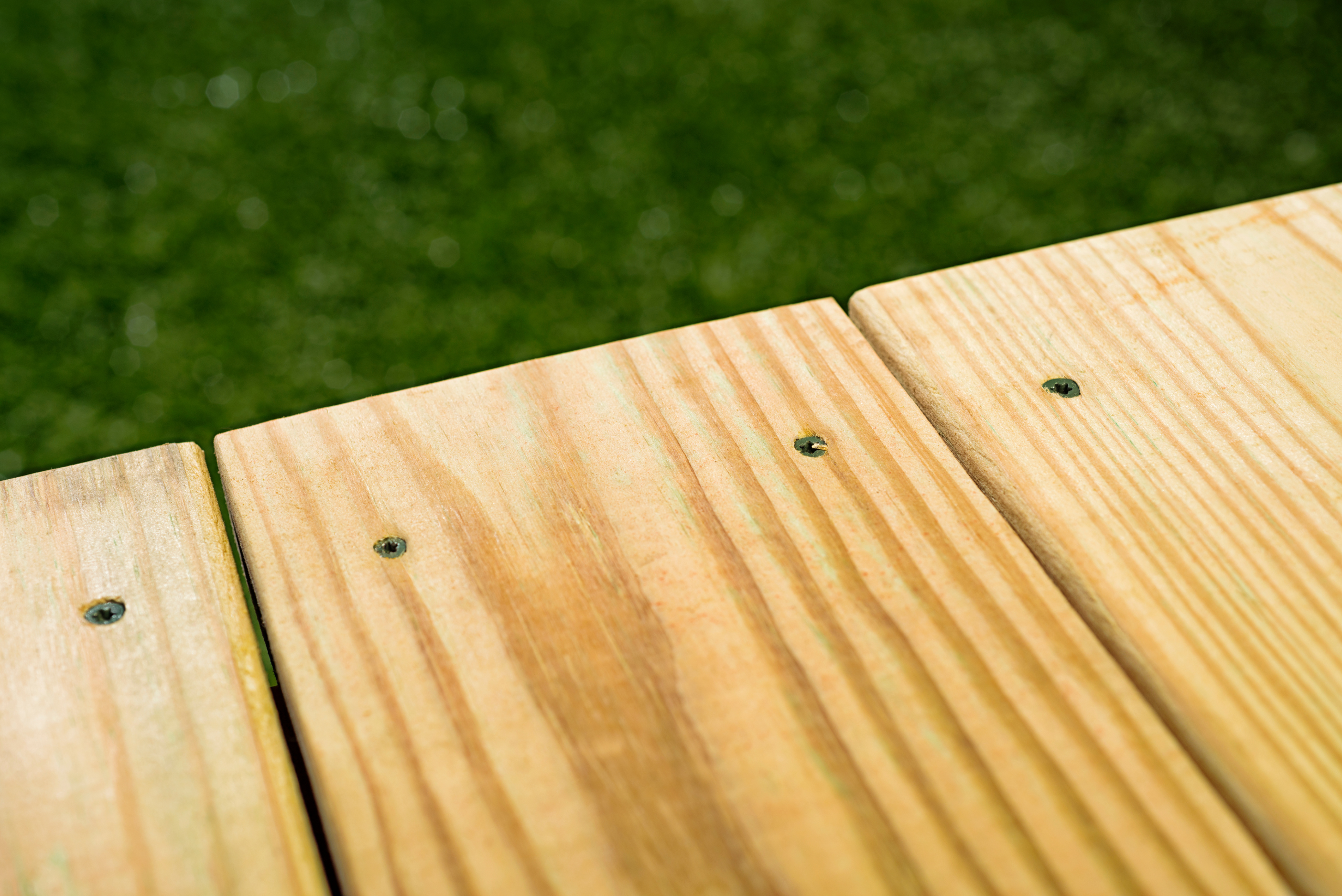 A deck made of pressure treated wood.