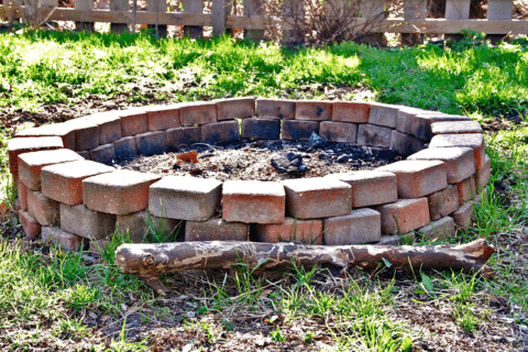 DIY brick fire pit in the ground.