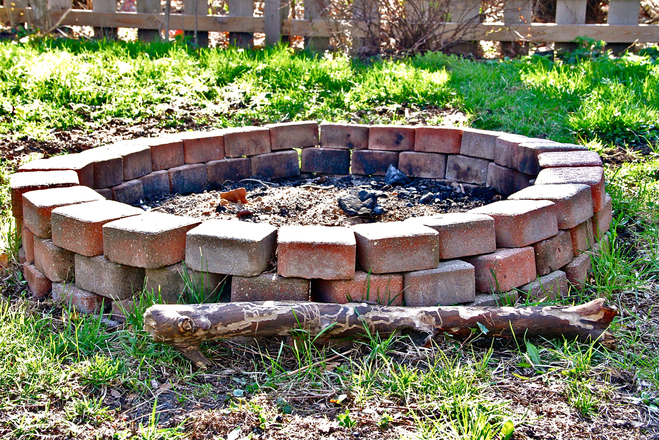 DIY brick fire pit in the ground.