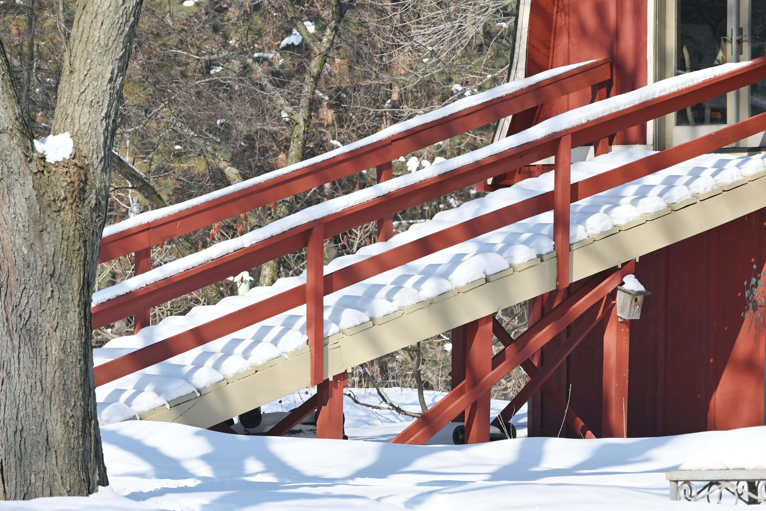 A red wooden ramp with handrails.