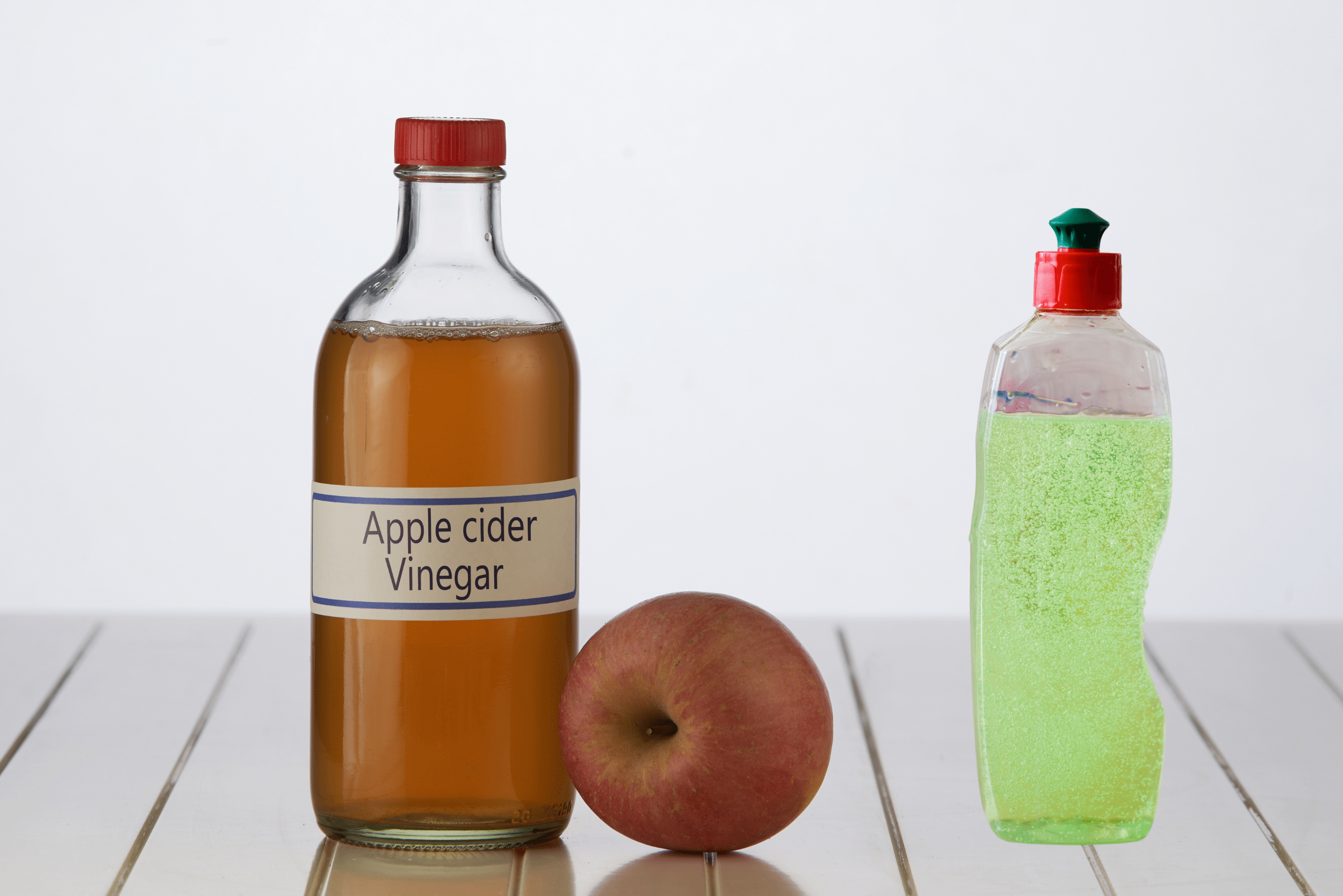 A bottle of apple cider vinegar and dishsoap