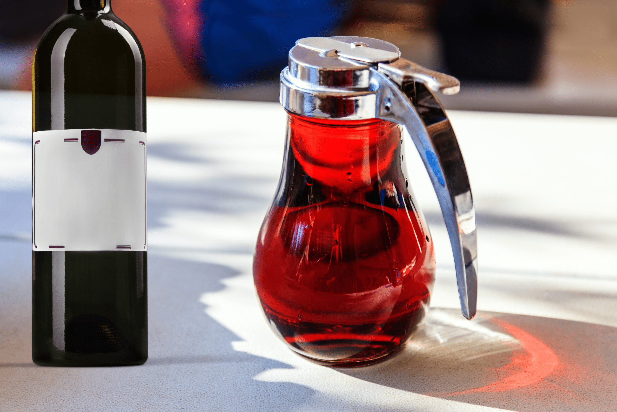 A bottle of wine and maple syrup on table.