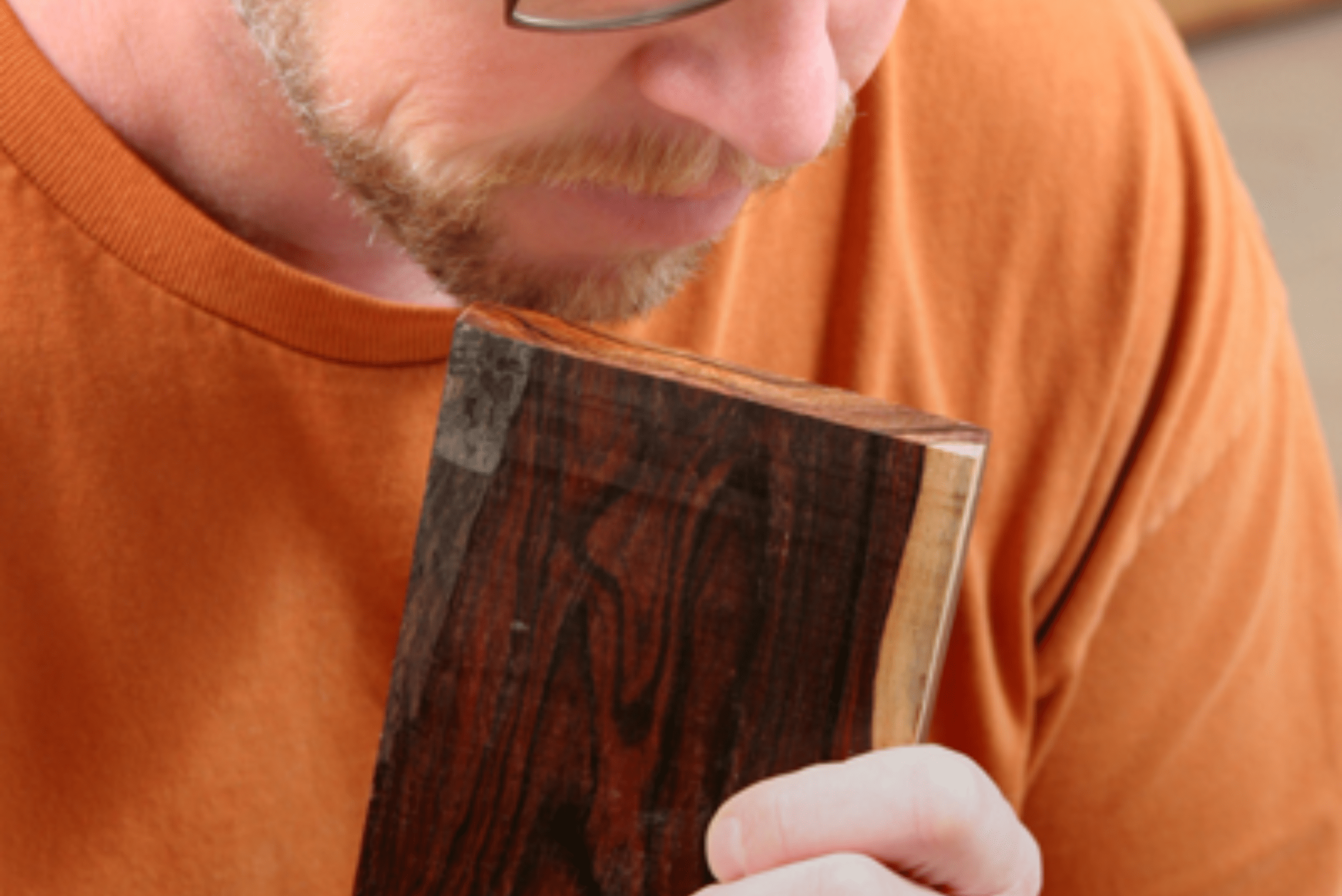 Man smelling wooden board.