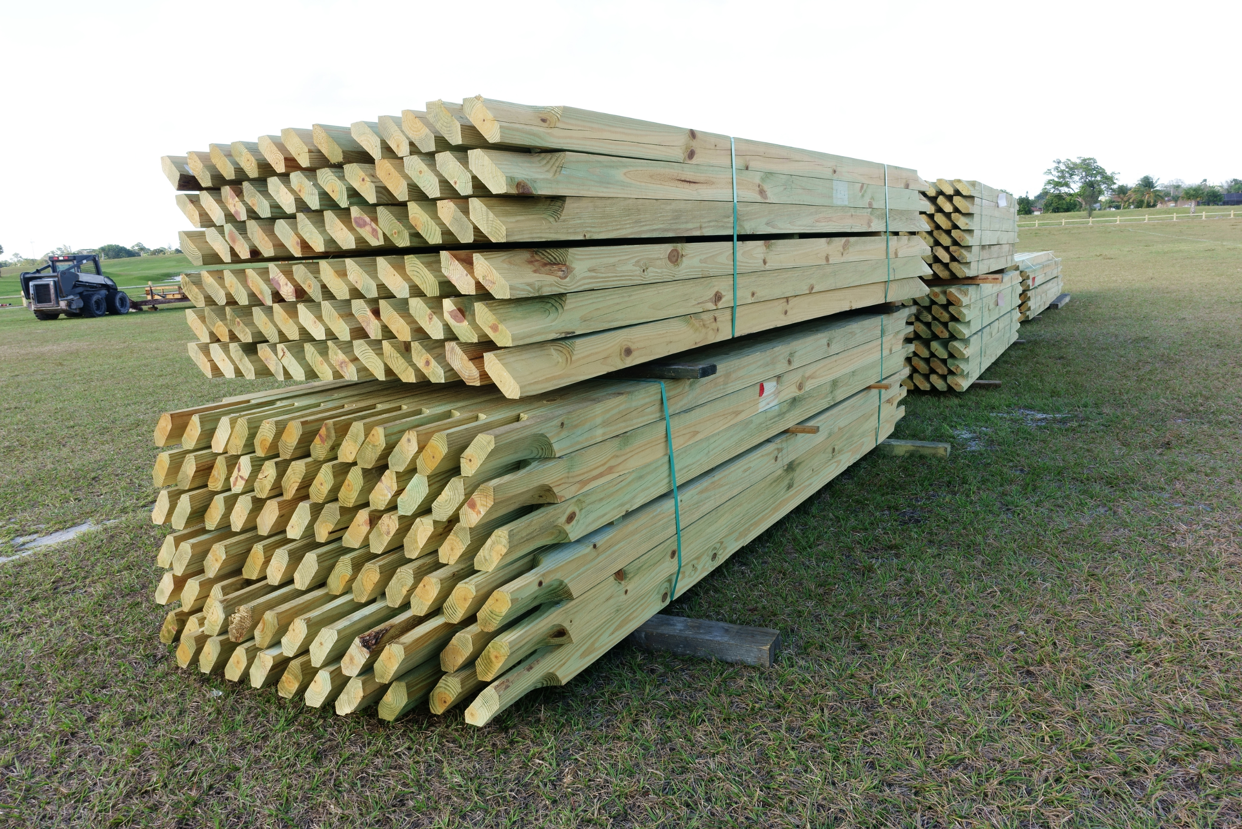 A stack of pressure treated wood in lumber yard.