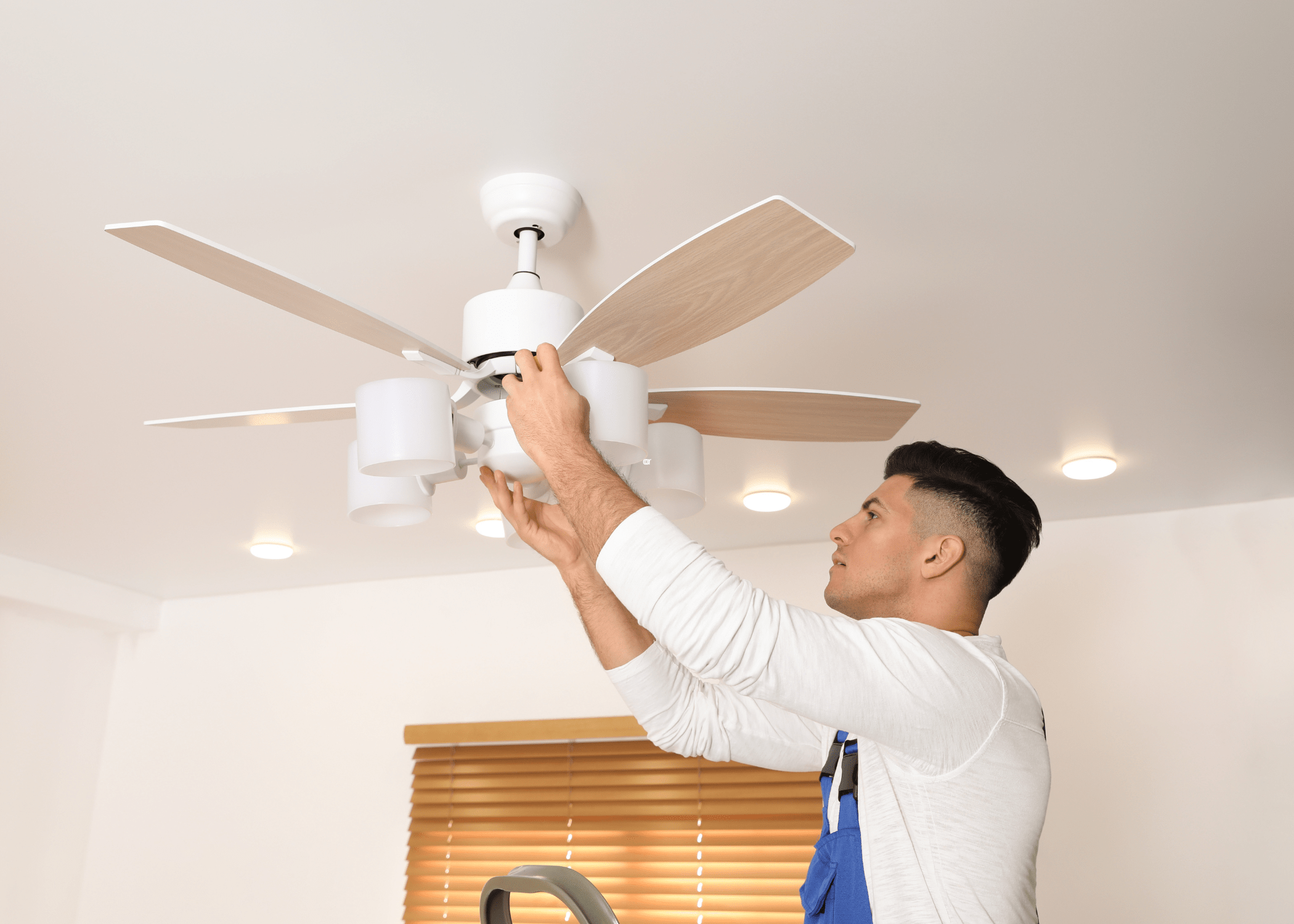 man fixing ceiling fan