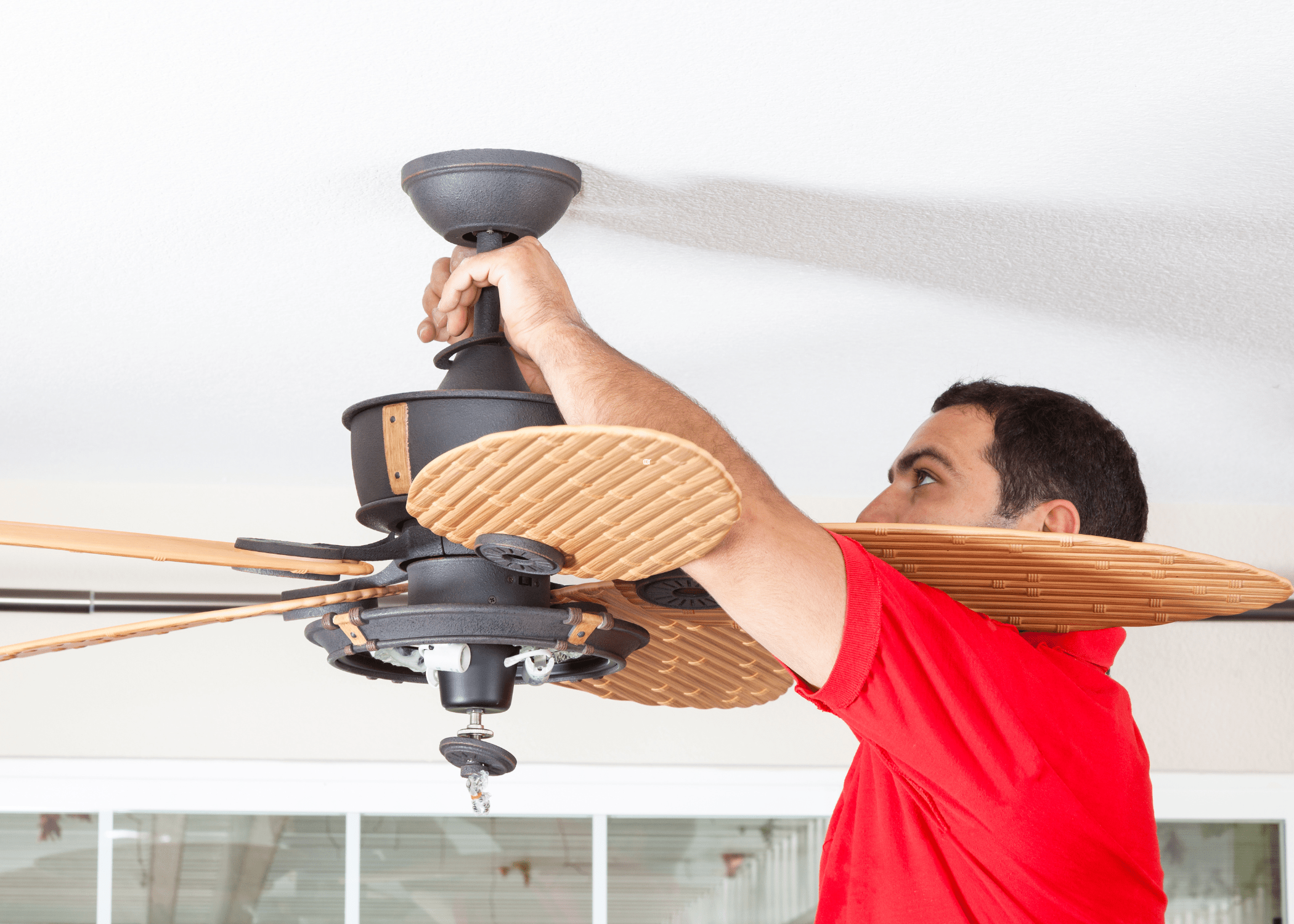 man fixing ceiling fan