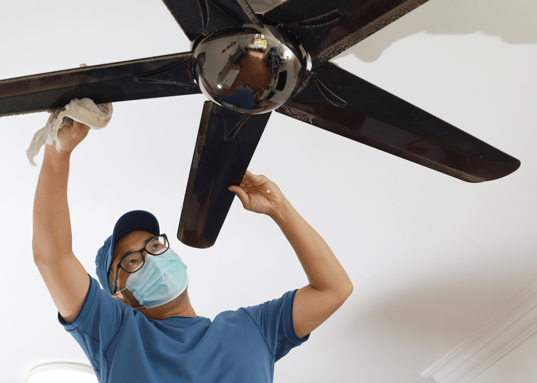 man fixing ceiling fan