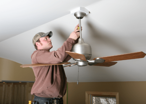 man fixing ceiling fan