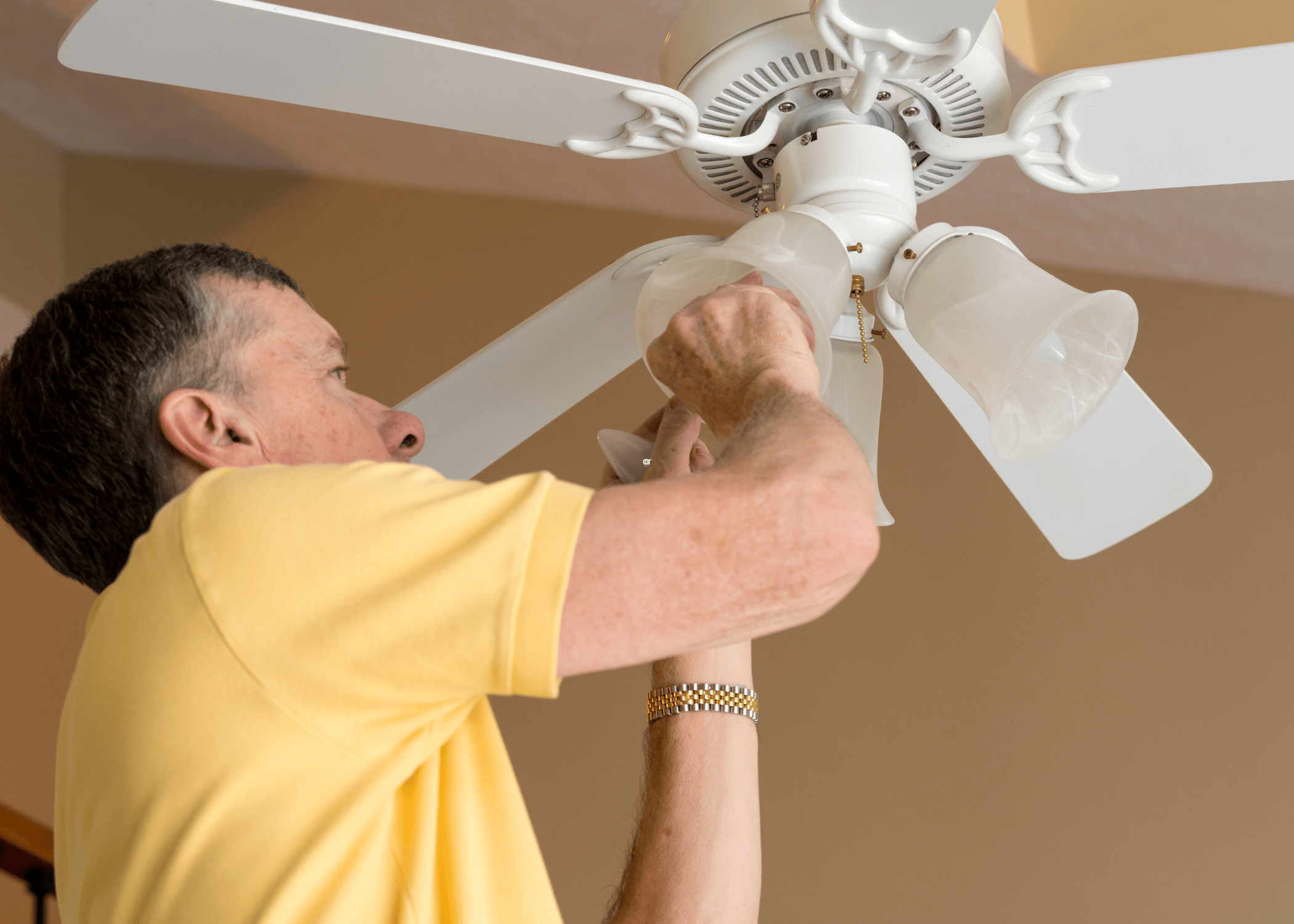 man fixing ceiling fan