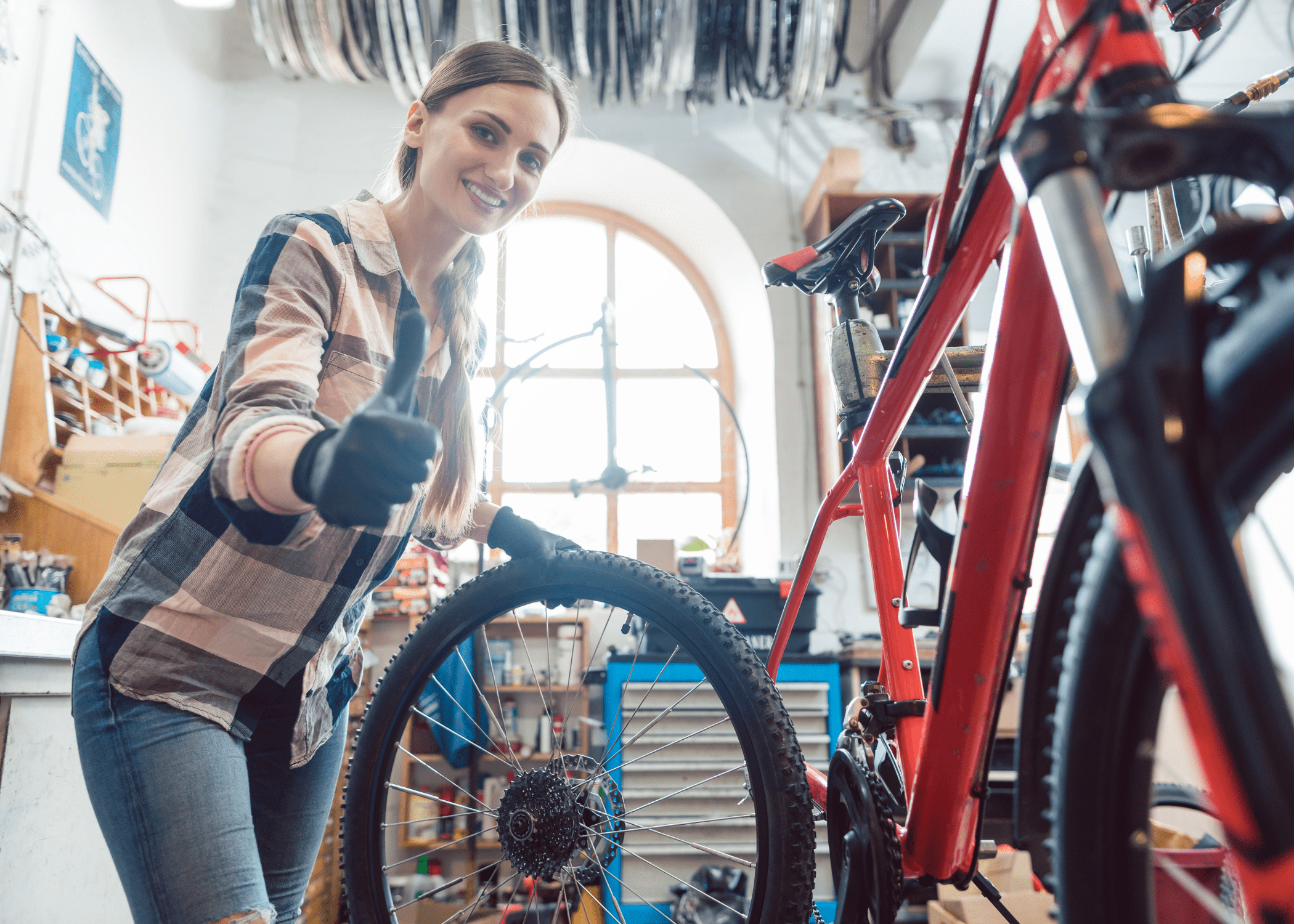 woman replacing a wheel on a bike