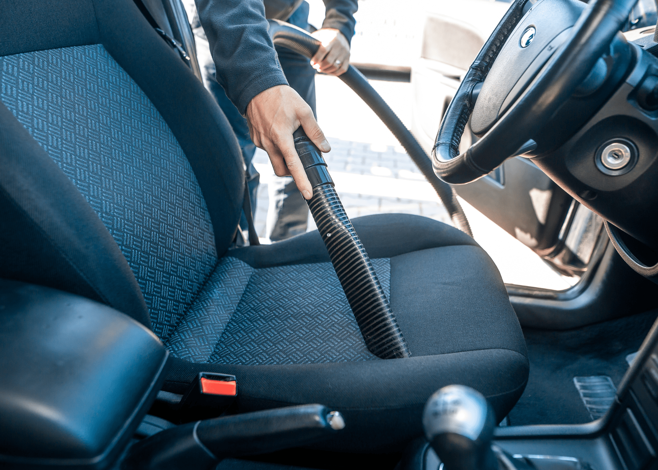 vacuuming interior of car