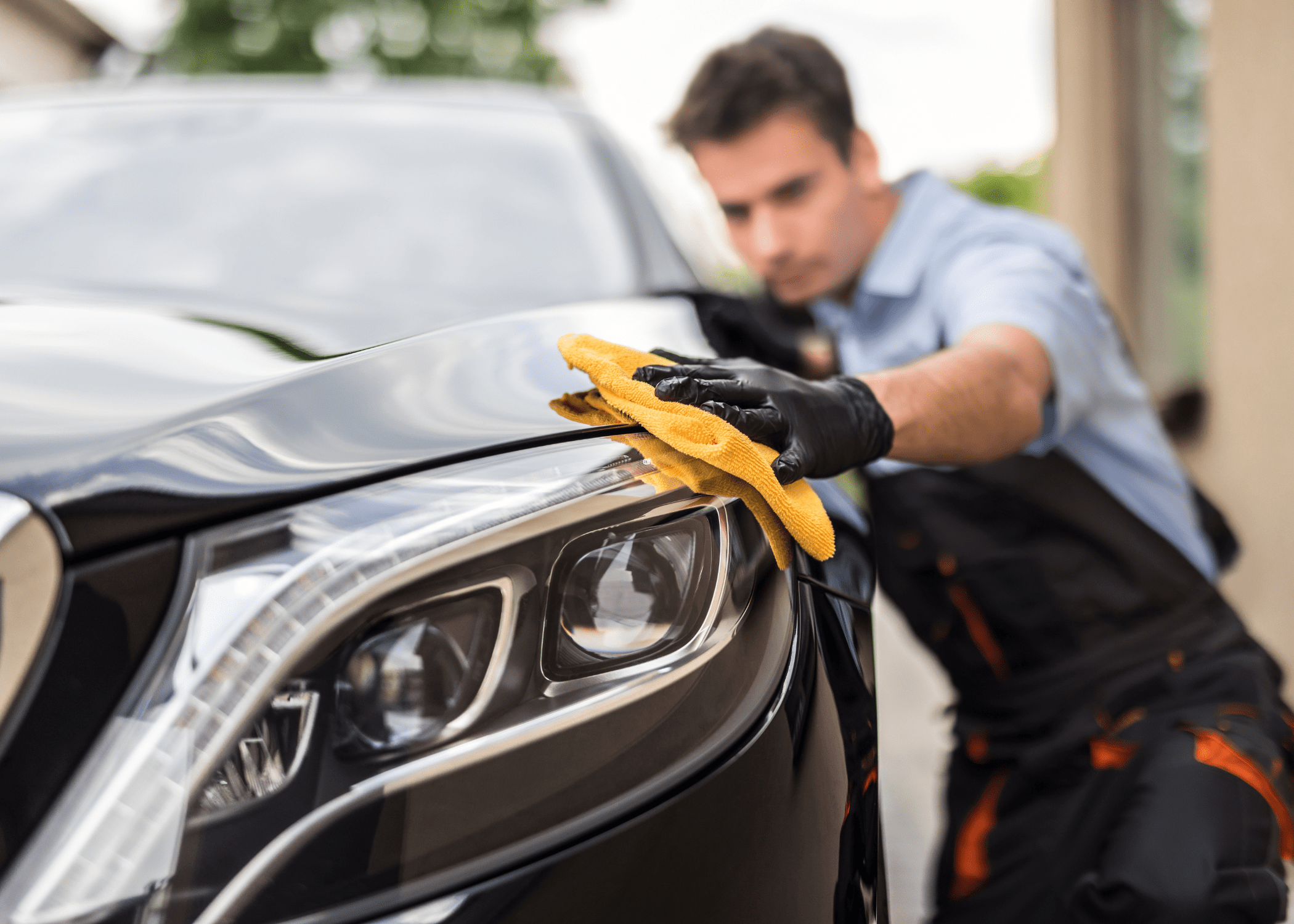 man wiping car with microfibre cloth