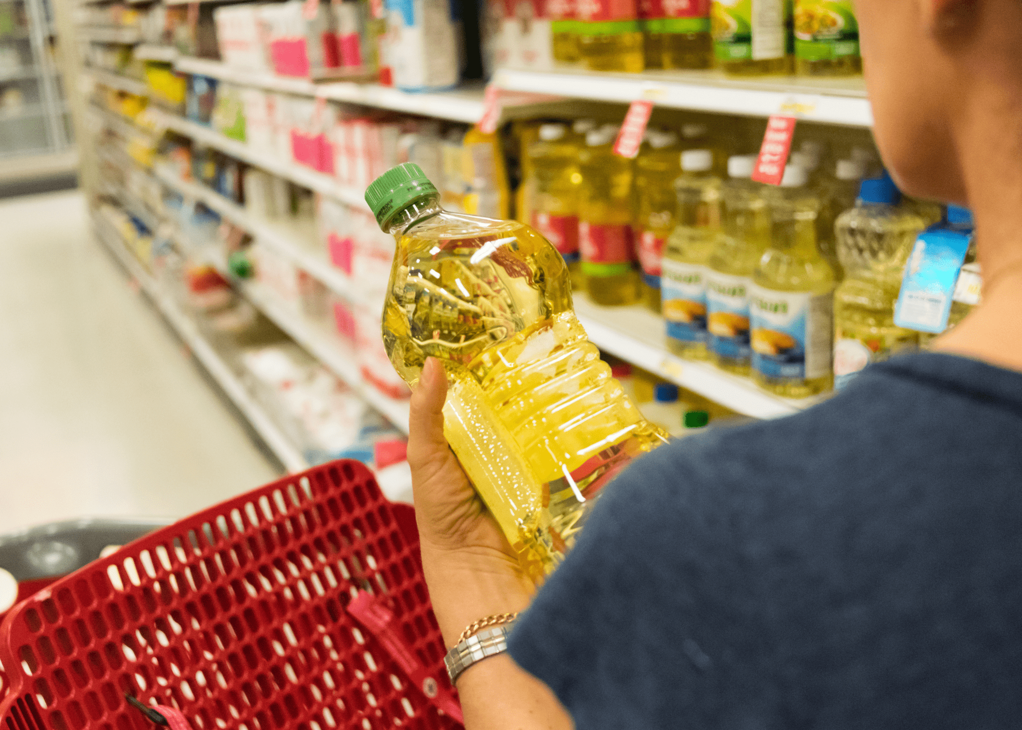 woman in grocery store looking at cooking oil