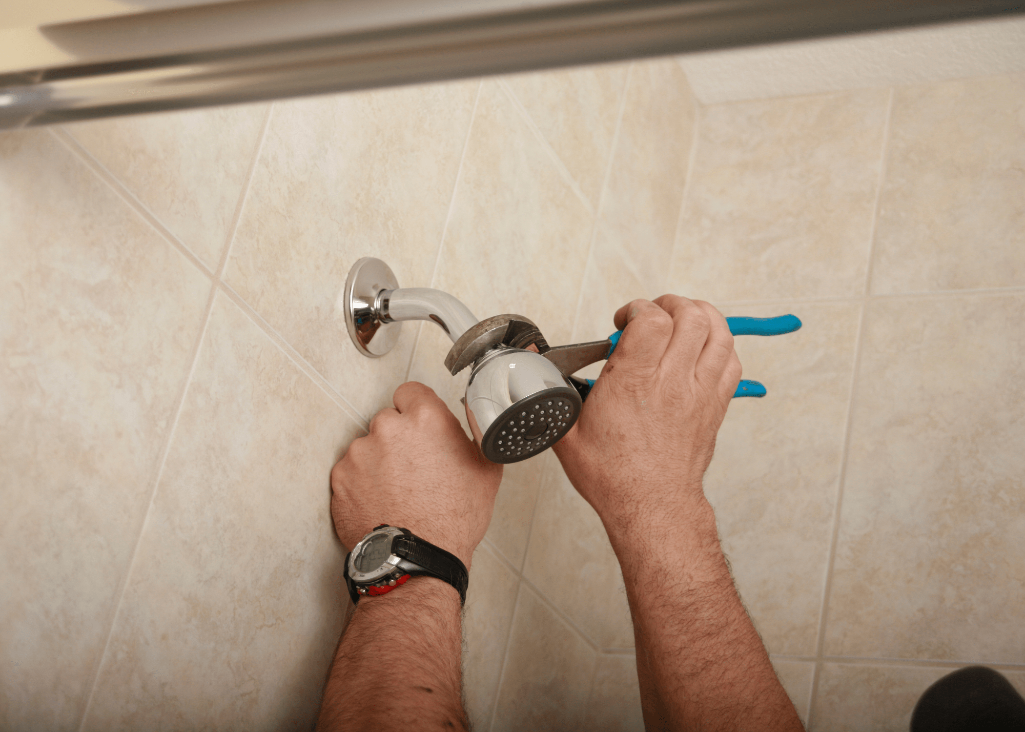 man tightening a shower head