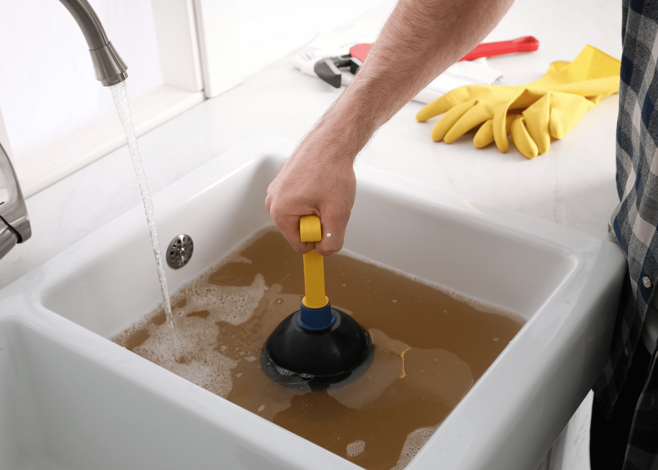 unclogging a drain with a plunger