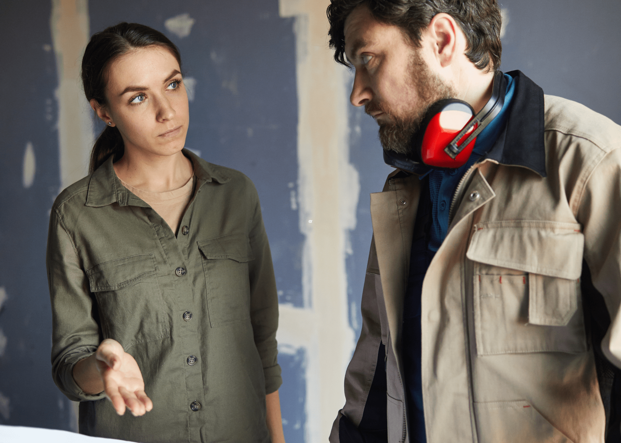 man and woman talking in home under going renovation