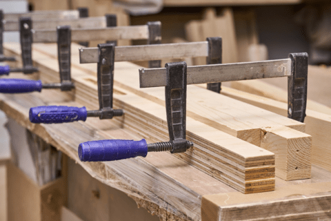 Bunch of clamps holding wood together as it's being glued.