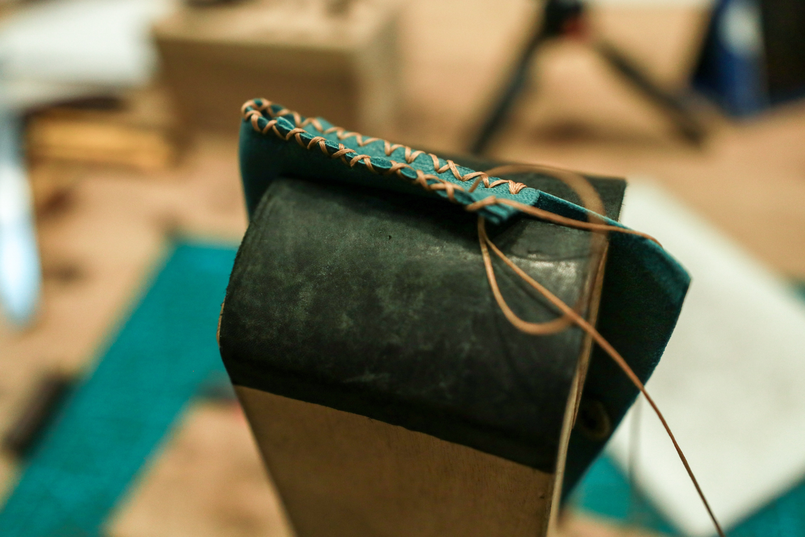 Finishing touches of stitching a leather wallet.