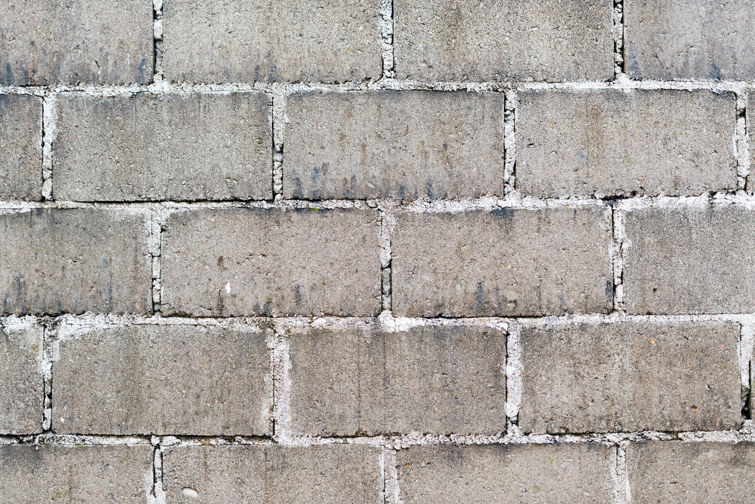 A cinder block retaining wall with cement in between. 