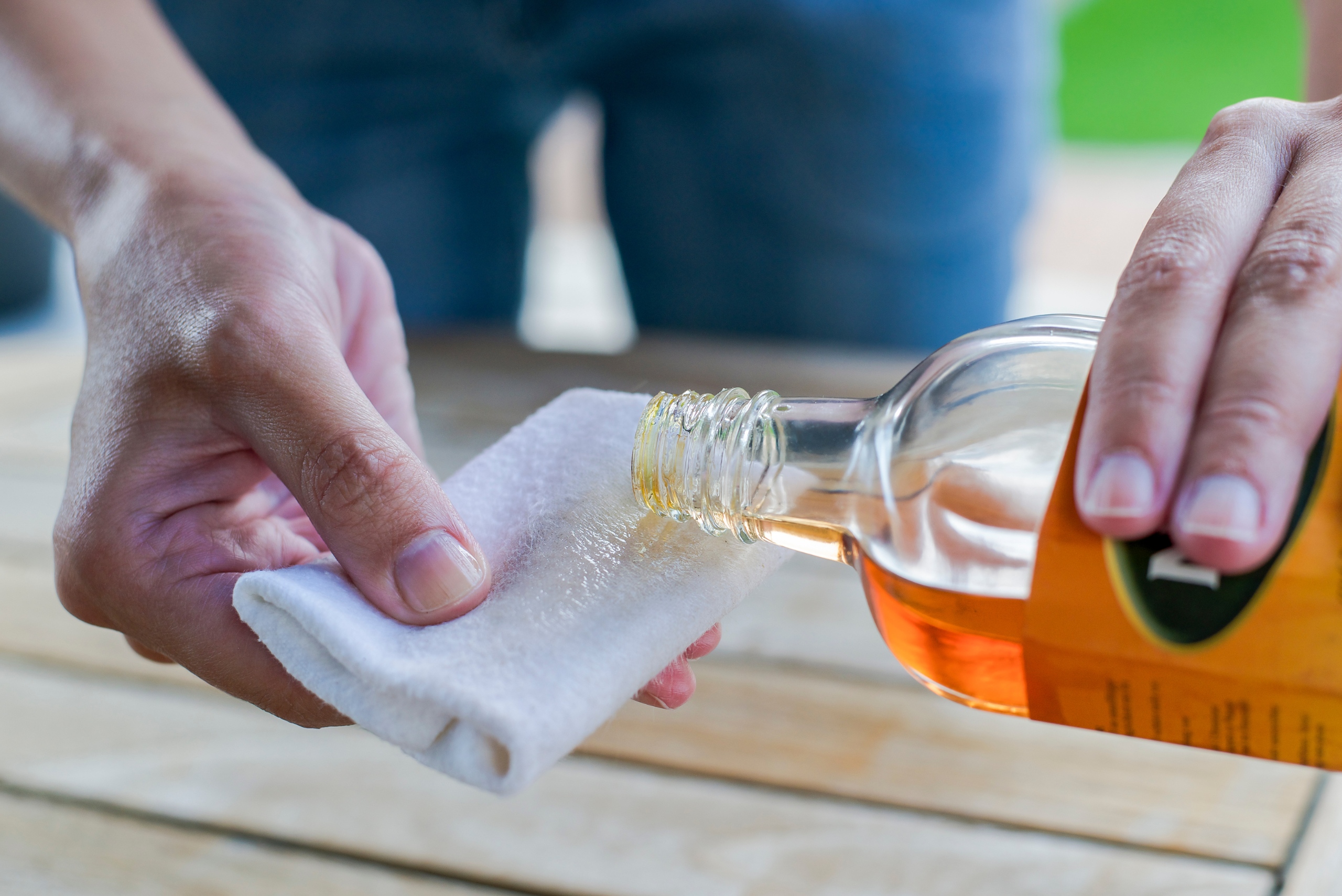 Pouring wood product on white cloth.