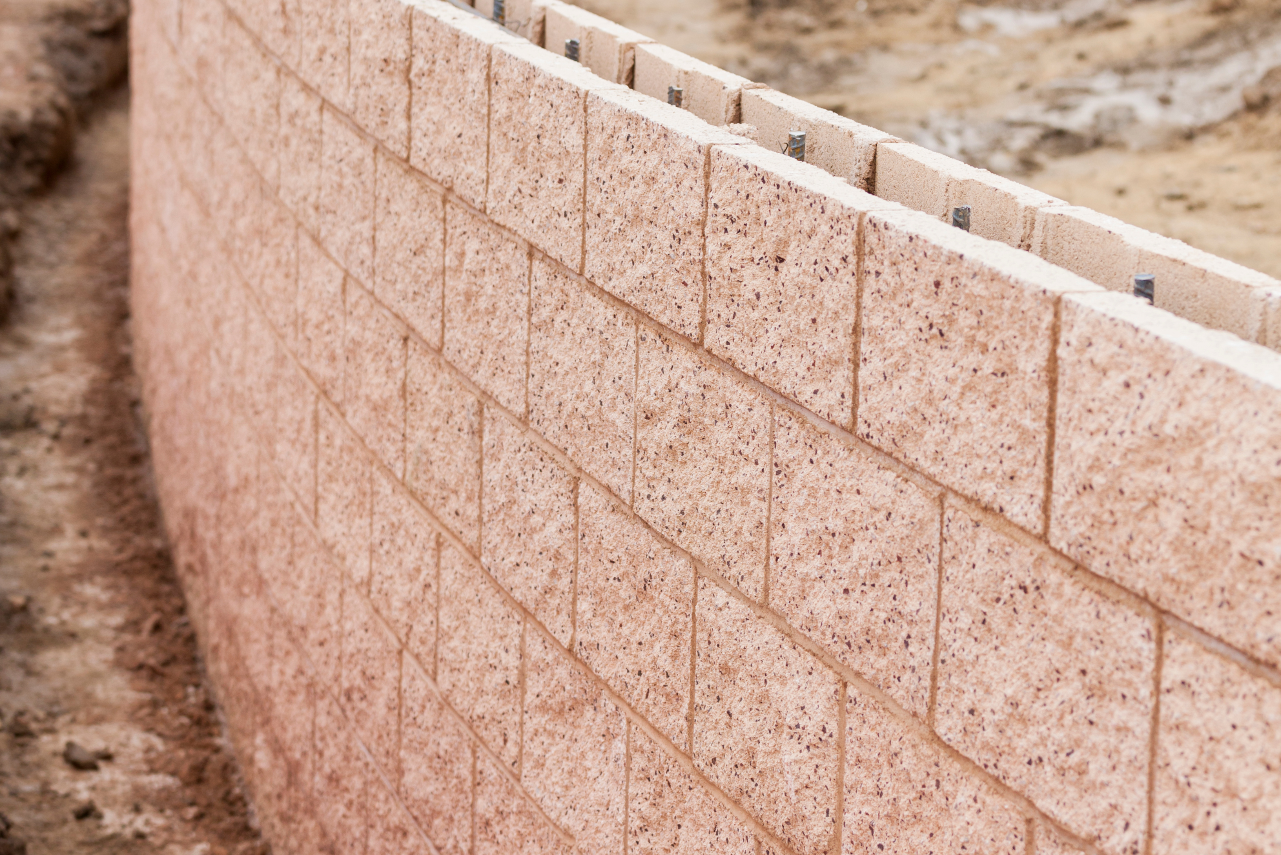 A cinder block retaining wall mid build.