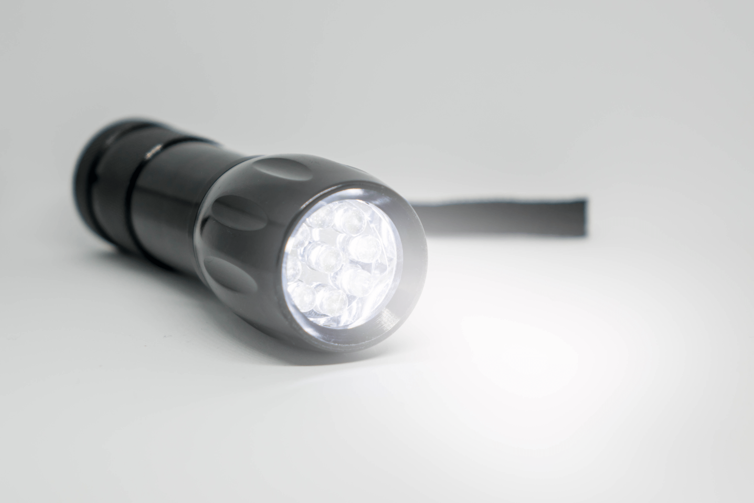 A black flashlight that's on.