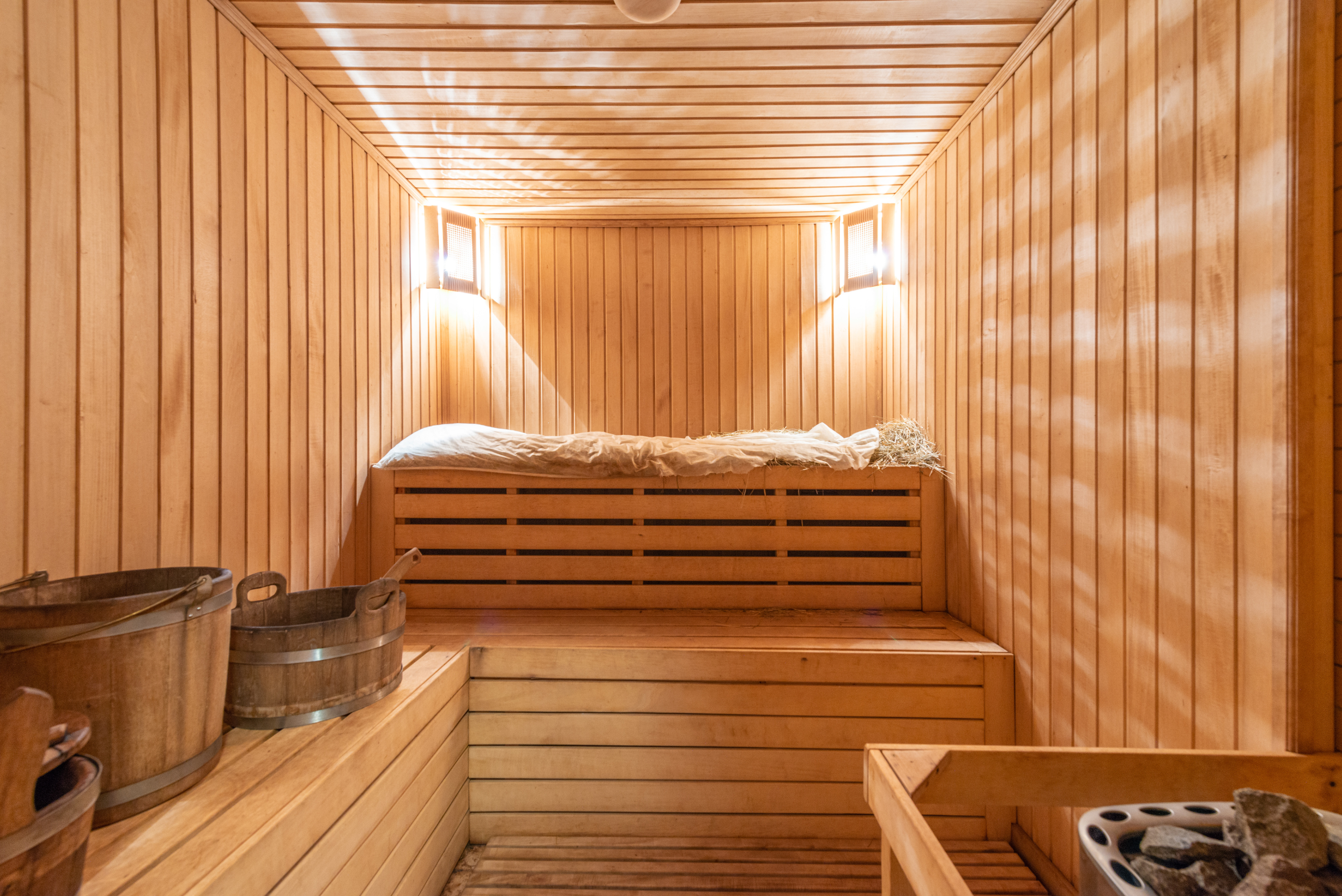 Interior of a wooden sauna with lights.