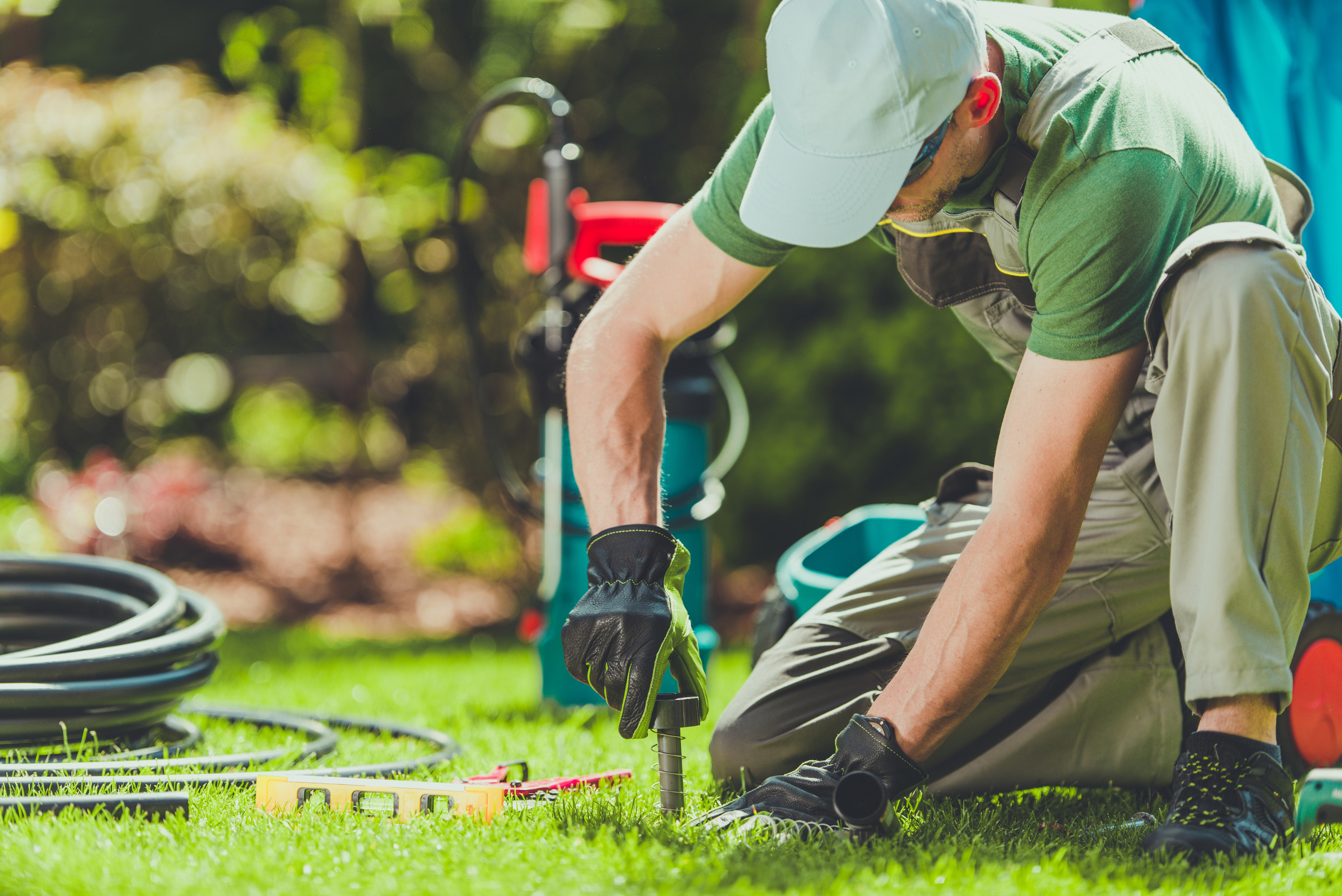 A person adjusting sprinkler system.