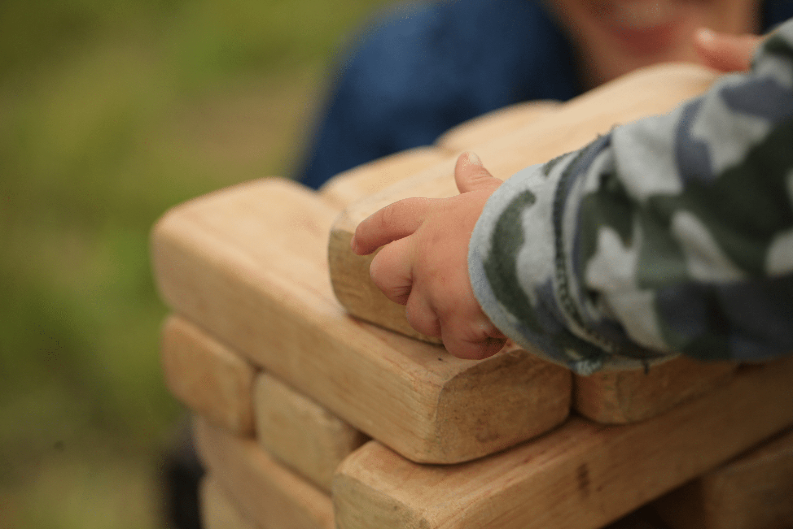 Kid playing with giant Jenga game.