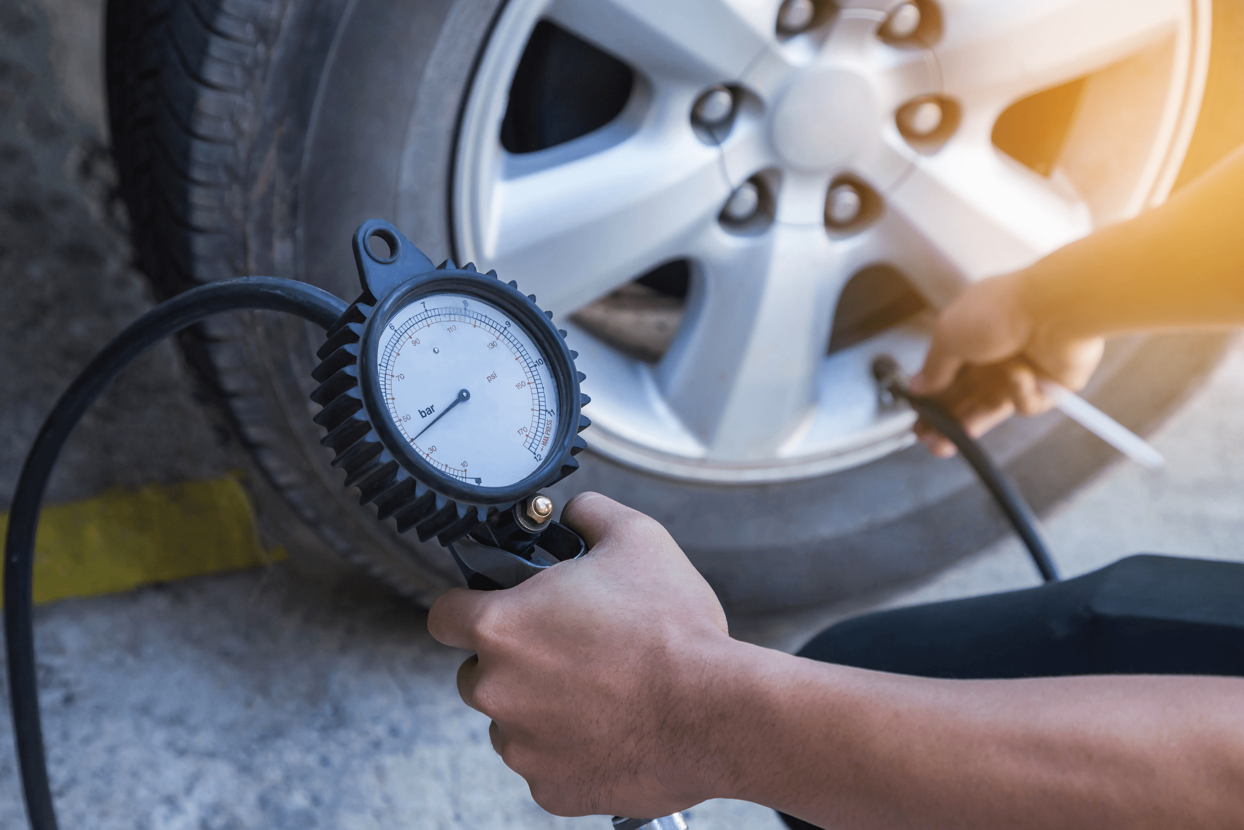 A person using a tire pressure gauge.