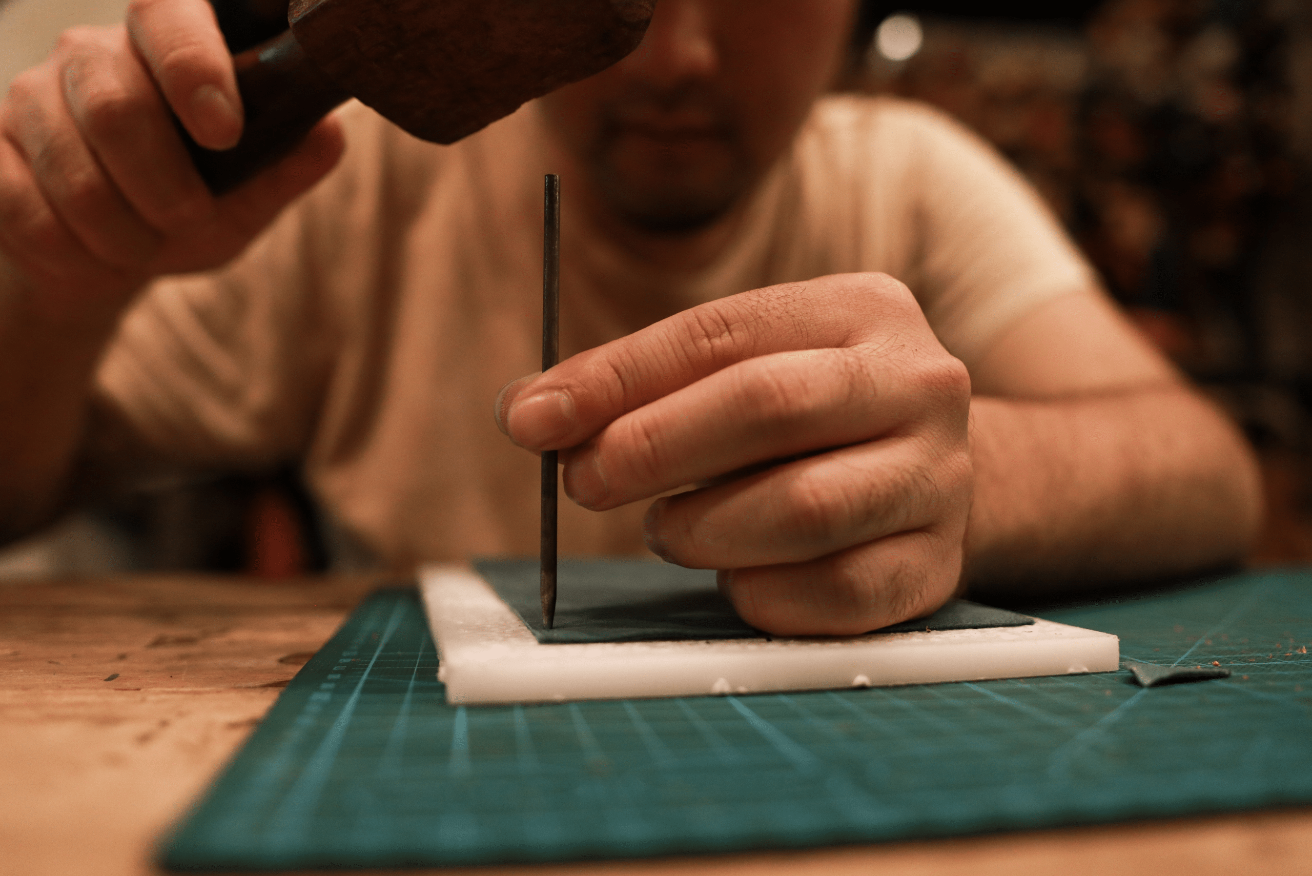 A person planning out a leather wallet design.