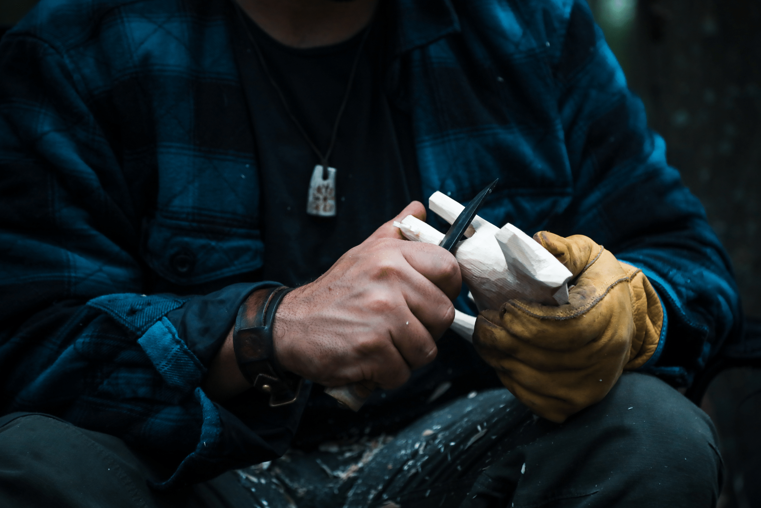 A person whittling wood animal.