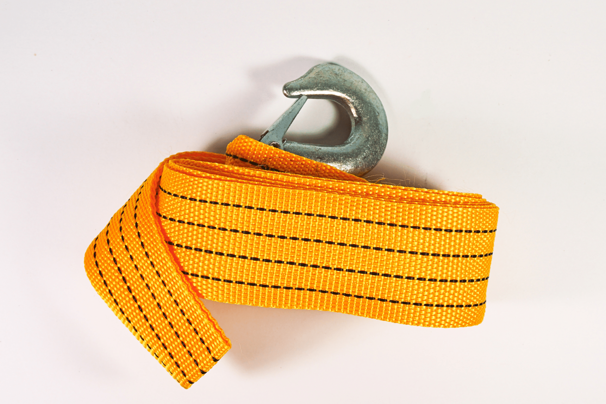 A yellow tow strap with metal hook.