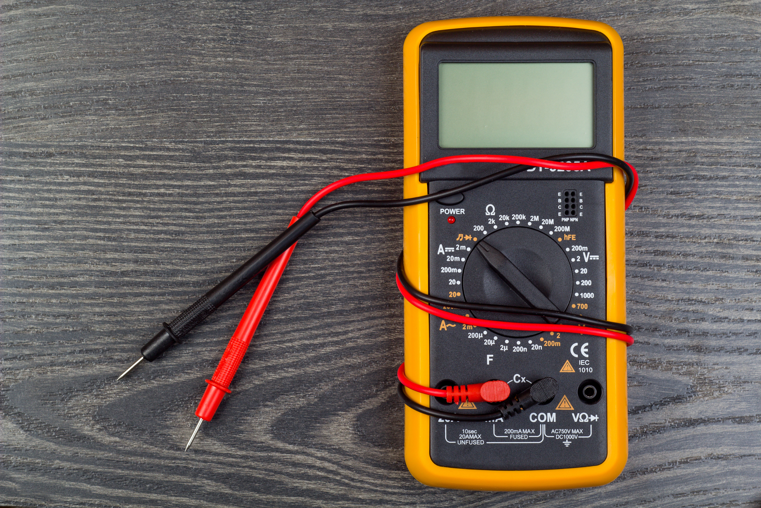 A black and yellow multimeter with red and black test wires.