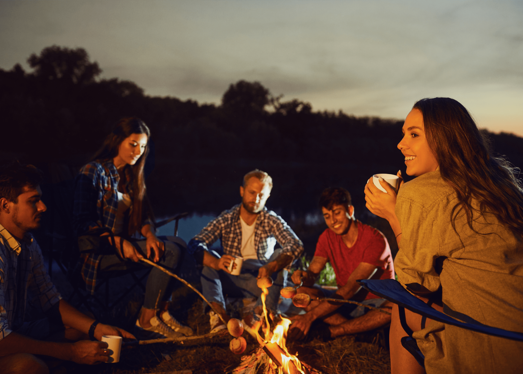 young adults at night campfire