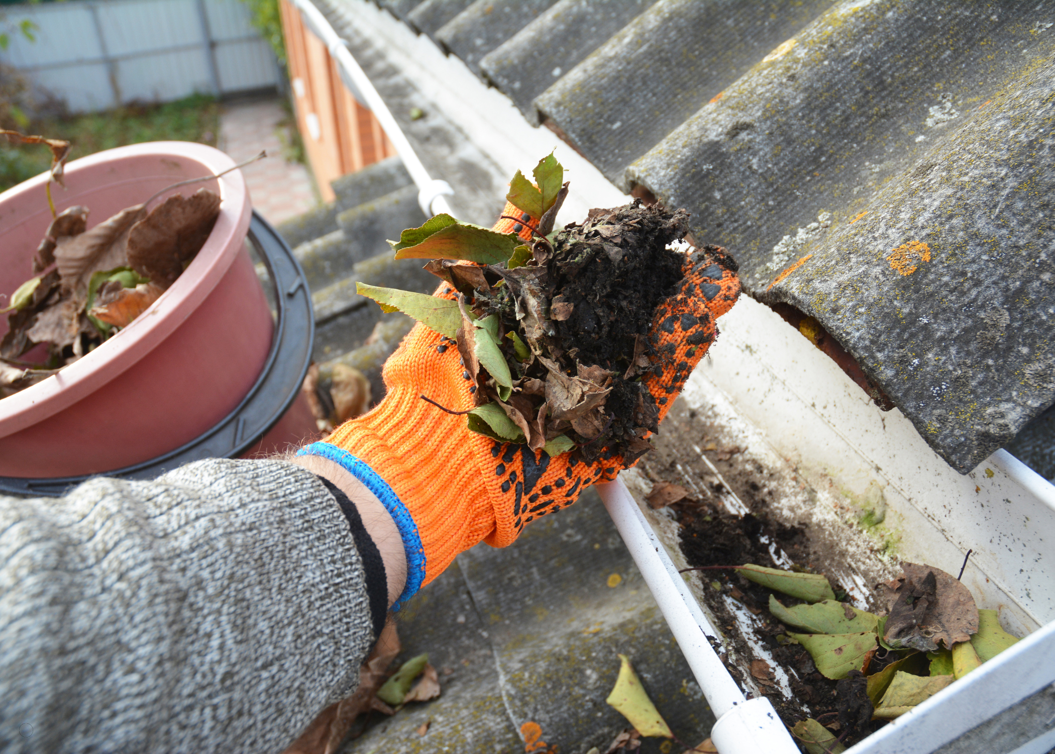 man cleaning gutters