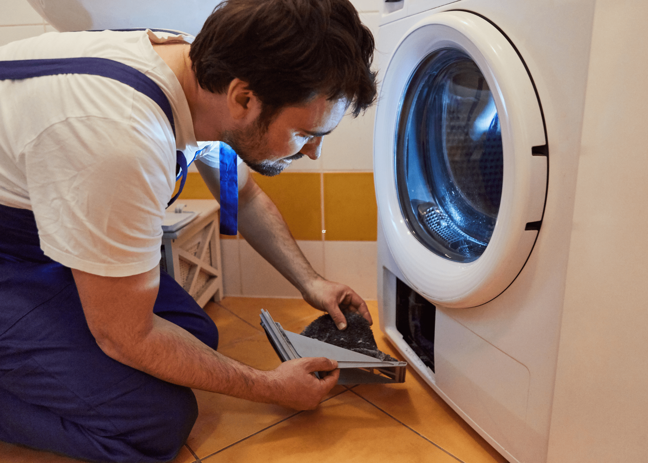 man cleaning out dryer lint trap