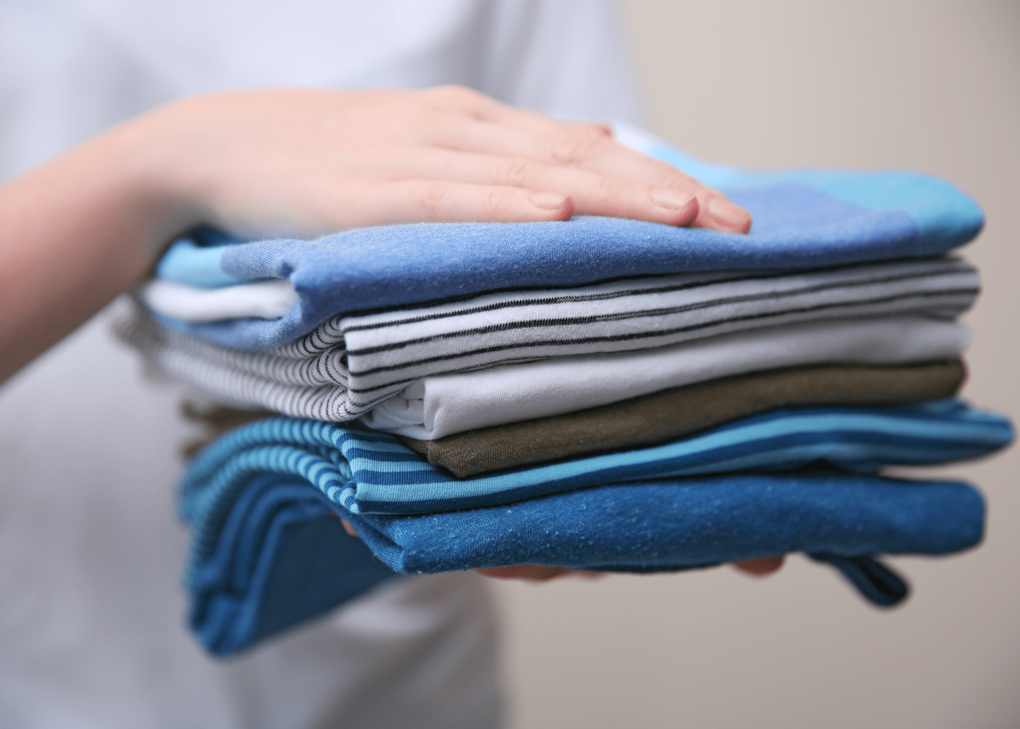 stack of folded dress shirts