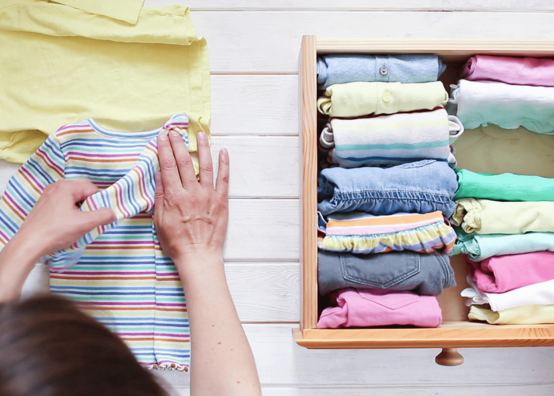 stacked folded shirts in drawer