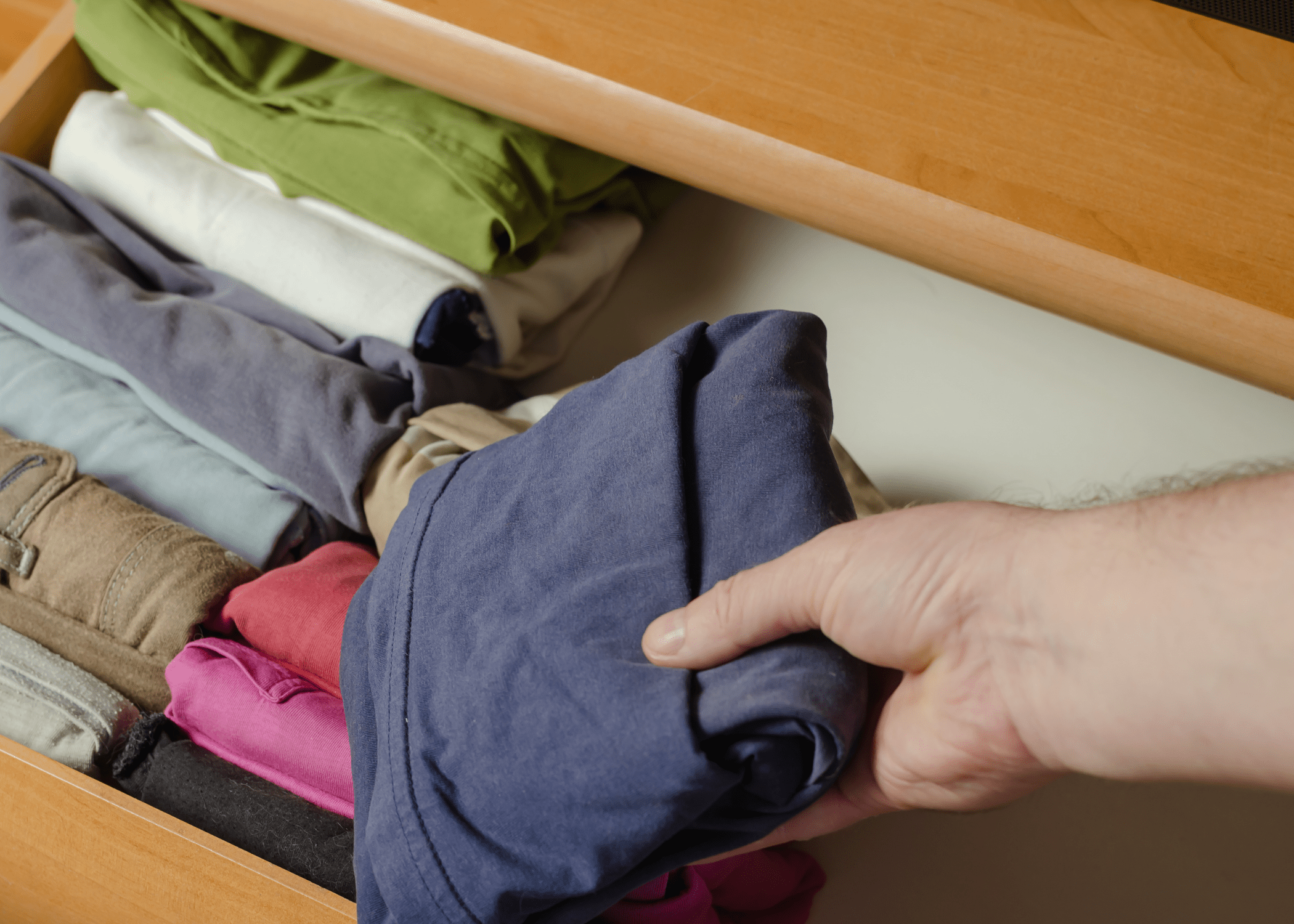 neat folded clothes going into drawer